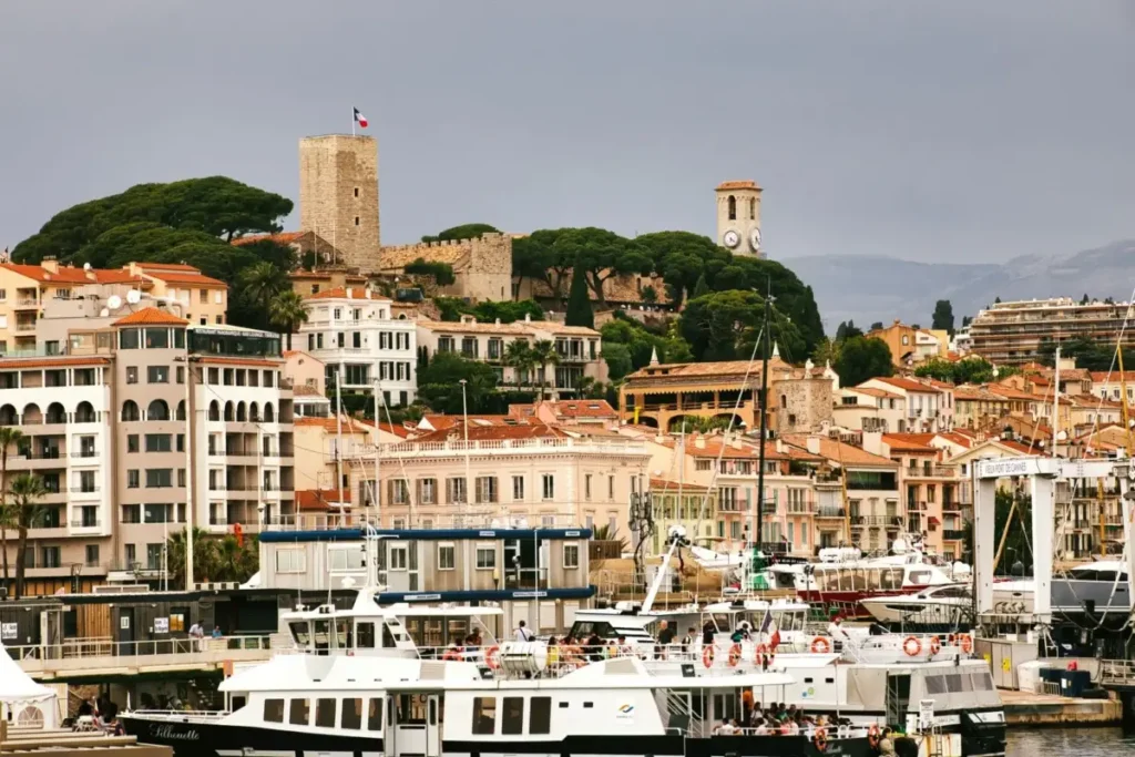 Boats moored in the Vieux-Port of Cannes below the Le Suquet old town tower