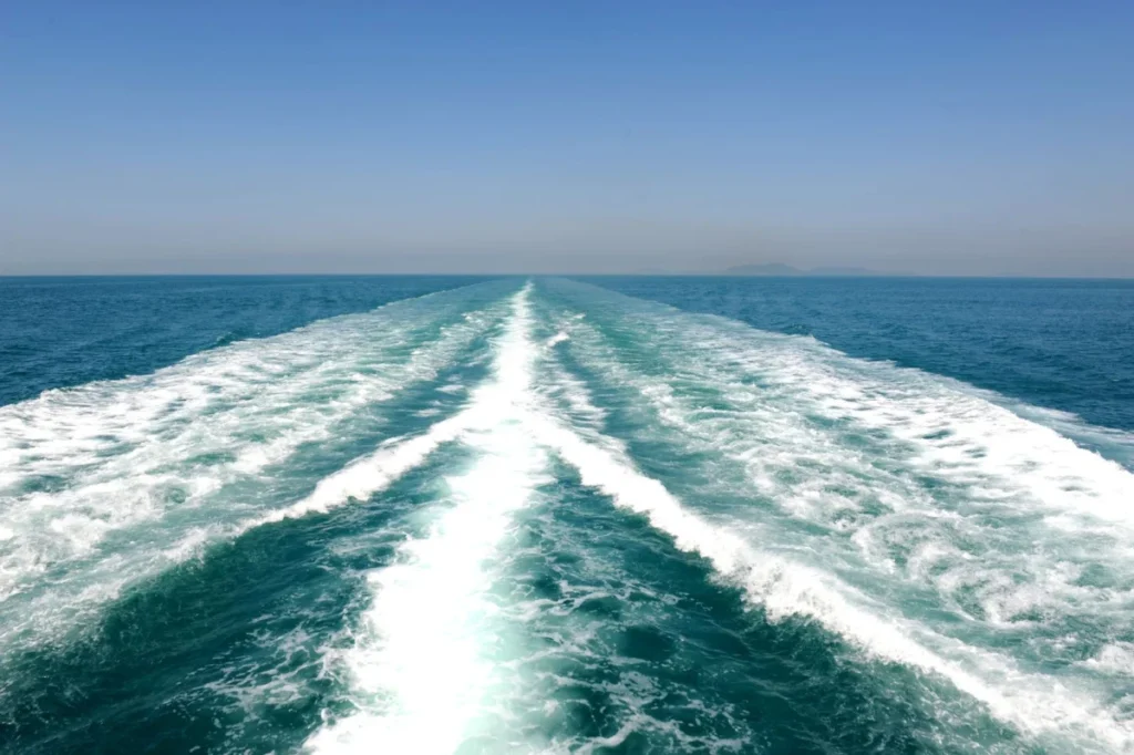White wake behind a ferry on a calm Mediterranean sea during a coastal crossing