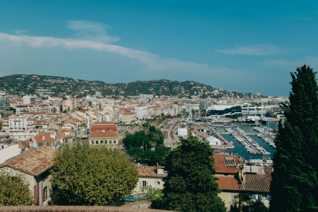 Is Cannes safe: view over Cannes rooftops, the Old Port and the hills on a sunny day